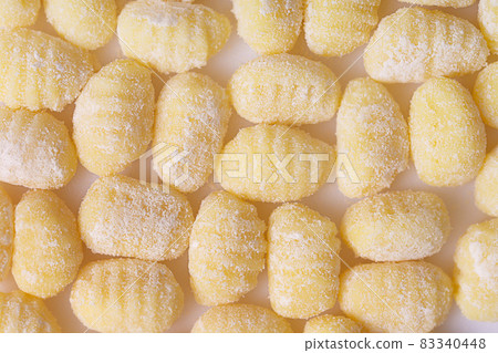 Raw italian gnocchi on a white background. Flat lay, pattern 83340448