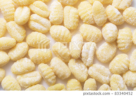 Raw italian gnocchi on a white background, top view 83340452