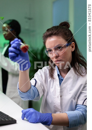 Chemist researcher doctor holding organic strawberry analyzing after injected with pesticides Chemist researcher doctor holding organic strawberry analyzing after injected with pesticides 83341878