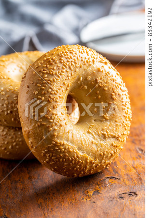Baked bagel with sesame seeds. Baked bagel with sesame seeds. 83342192