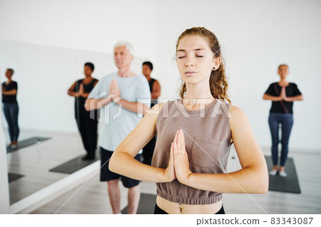 People meditating in gym class 83343087