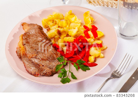 Beef entrecote with fried potato and baked sweet pepper Beef entrecote with fried potato and baked sweet pepper 83343208