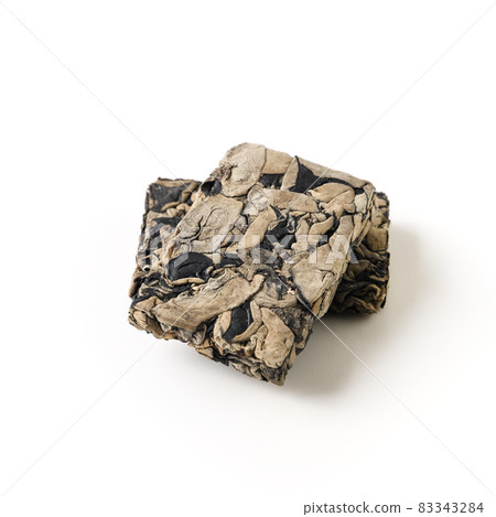 Chinese dry pressed tree black muer mushroom in briquette isolated on white background. 83343284