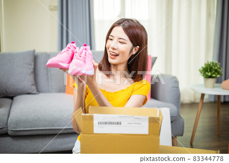 woman open delivery boxes woman open delivery boxes 83344778