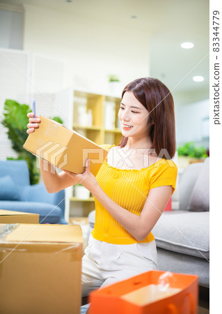 woman open delivery boxes woman open delivery boxes 83344779