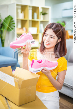 woman open delivery boxes woman open delivery boxes 83344780