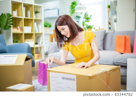 woman open delivery boxes woman open delivery boxes 83344782