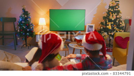couple watch TV while Christmas couple watch TV while Christmas 83344791