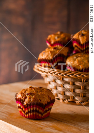 Appetizing homemade muffins on a wooden cutting board. Traditional festive Christmas baking. 83345612