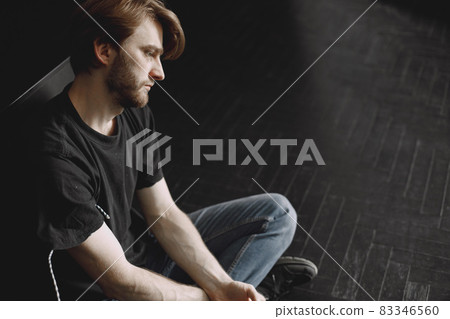 Male druggy sitting relaxed after taking dose Male druggy sitting relaxed after taking dose 83346560