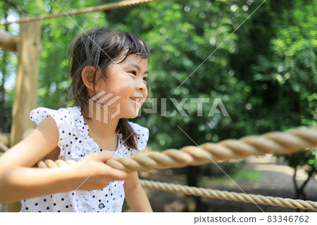 Elementary school girl playing on a tightrope (6 years old) 83346762