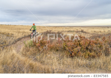 senior cyclist on mountain bike in Colorado prairie 83347565