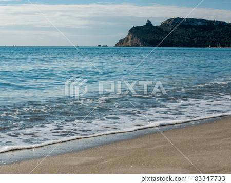 view from the beach with waves on the shore of the Sella del Diavolo mountain view from the beach with waves on the shore of the Sella del Diavolo mountain 83347733