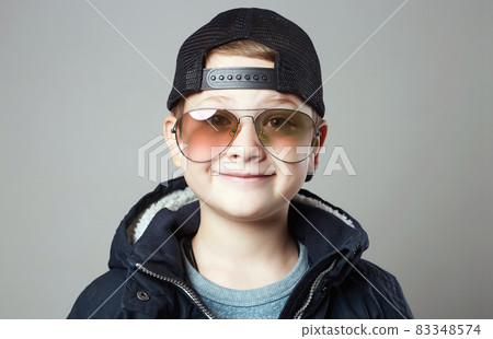 Funny little boy in glasses and cap. stylish smiling kid 83348574