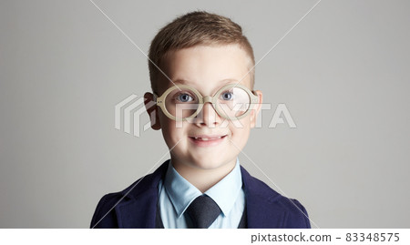 smiling boy with glasses and tie 83348575
