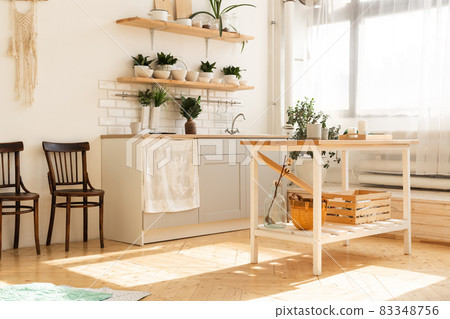 Stylish scandinavian open space with kitchen accessories and plants. 83348756