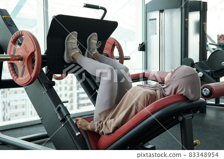 Young Muslim woman pushing part of sports equipment 83348954