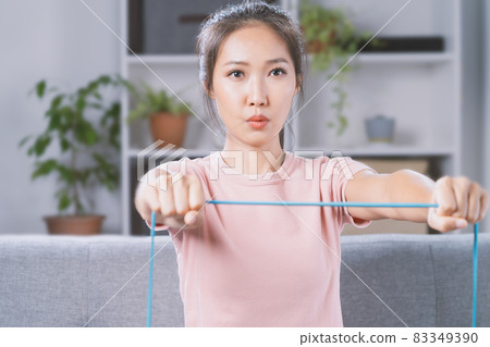 New normal.A woman is exercising inside the house. 83349390