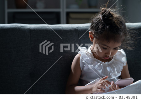 The girl is using the phone at night. 83349391
