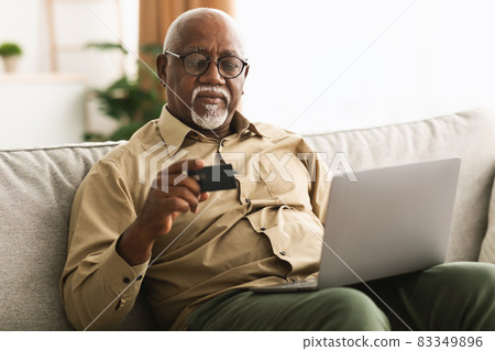 African Man Shopping Online Using Credit Card And Laptop Indoor African Man Shopping Online Using Credit Card And Laptop Indoor 83349896