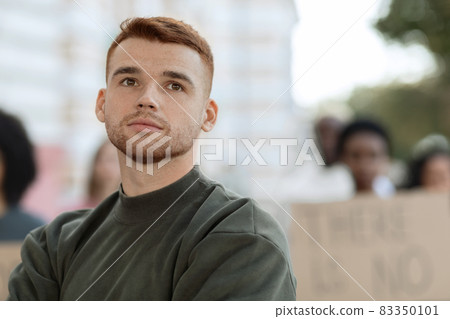 Closeup of caucasian guy leader guiding international group of protestors 83350101