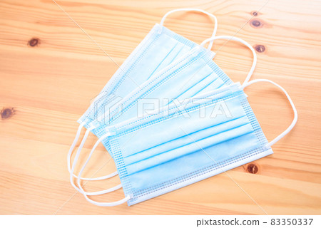 Three surgical masks on a wood grain table Non-woven mask New coronavirus infection prevention measures Prevention 83350337