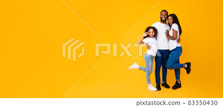 African American man hugging his wife and excited daughter African American man hugging his wife and excited daughter 83350430