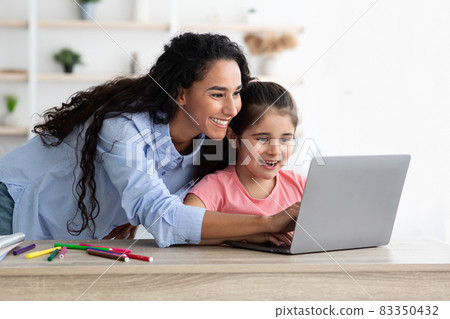 Loving Mother Helping Her Cute Daughter With Online Homework During Distance Learning Loving Mother Helping Her Cute Daughter With Online Homework During Distance Learning 83350432