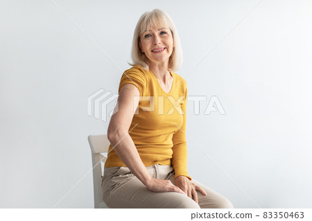 Senior Patient Woman Showing Vaccinated Arm With Plaster, Gray Background 83350463