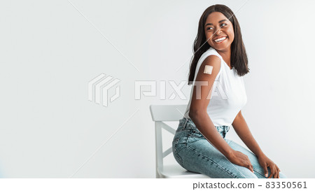 Happy Vaccinated Woman With Adhesive Bandage On Shoulder Looking Away 83350561