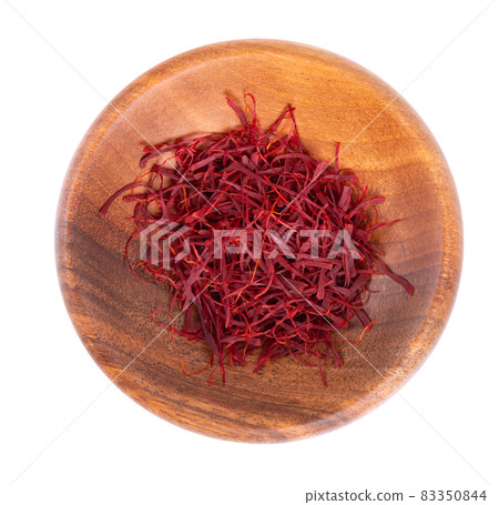 Saffron in wooden bowl, isolated on white background. Natural dry saffron threads, from crocus flowers. Clipping path. Top view. Saffron in wooden bowl, isolated on white background. Natural dry saffron threads, from crocus flowers. Clipping path. Top view. 83350844
