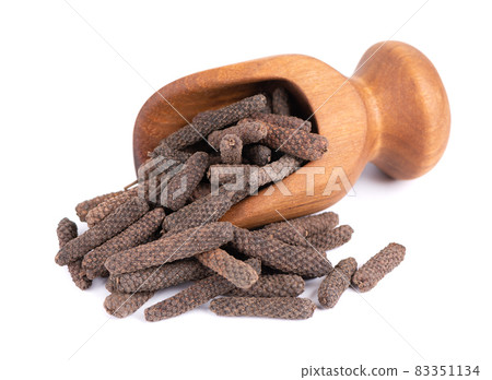 Long pepper in wooden scoop, isolated on white background. Heap of pippali or piper longum. Long pepper in wooden scoop, isolated on white background. Heap of pippali or piper longum. 83351134