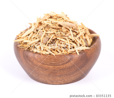 Muira Puama herbal tea in wooden bowl, isolated on white background. Natural potency wood, medicinal plant, dry tea. Ptychopetalum olacoides. 83351135