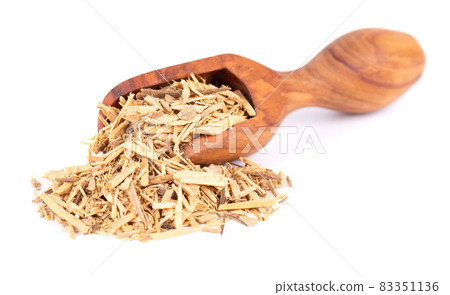 Muira Puama herbal tea in wooden scoop, isolated on white background. Natural potency wood, medicinal plant, dry tea. Ptychopetalum olacoides. 83351136
