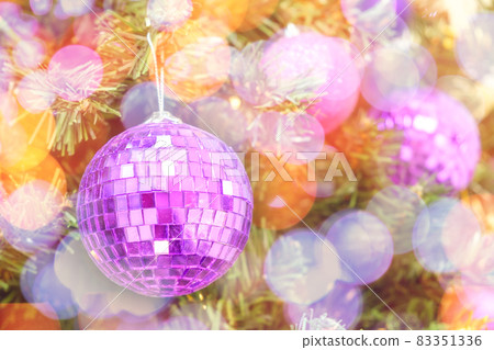 Christmas bokeh lights on a Christmas tree with purple balls background. New Year composition with copy space Christmas bokeh lights on a Christmas tree with purple balls background. New Year composition with copy space 83351336