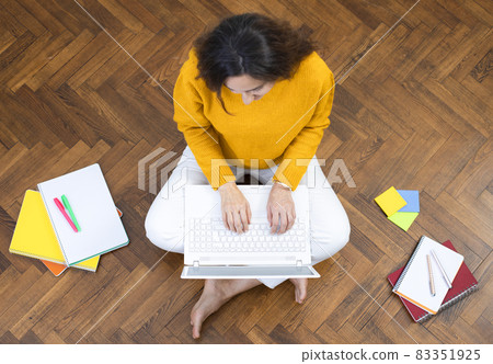 Young woman working on laptop at home. 83351925