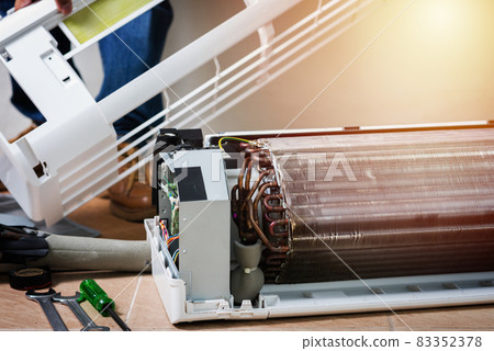 repairing the air conditioner repairing the air conditioner 83352378