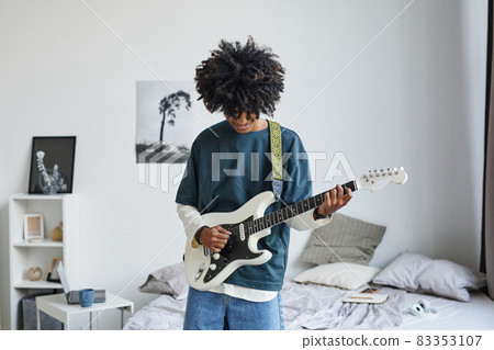 African American Teenager Playing Guitar at Home African American Teenager Playing Guitar at Home 83353107