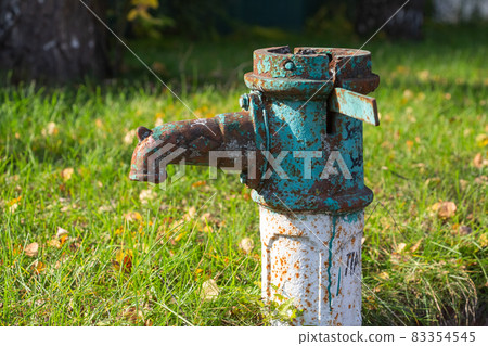 Old rusty water column in autumn, selective focus, blurred background Old rusty water column in autumn, selective focus, blurred background 83354545