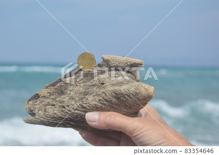 Coin in denomination of 50 euro cents on the Aegean coast on the island of Rhodes in Greece Coin in denomination of 50 euro cents on the Aegean coast on the island of Rhodes in Greece 83354646