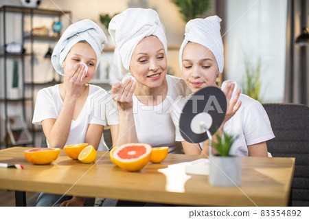Mother and daughters enjoying beauty routine at home Mother and daughters enjoying beauty routine at home 83354892
