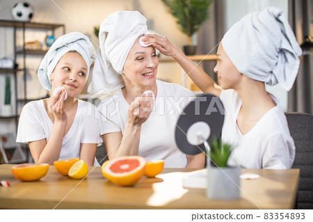 Mother and daughters enjoying beauty routine at home 83354893