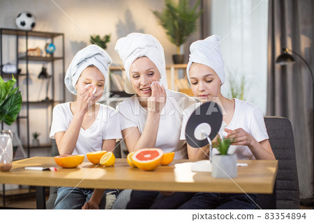 Mother and her two daughters doing beauty procedures Mother and her two daughters doing beauty procedures 83354894