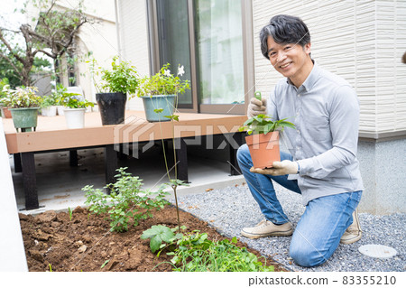 Middle man gardening in his garden 83355210