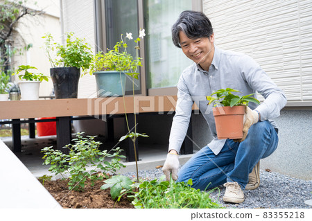 Middle man gardening in his garden Middle man gardening in his garden 83355218