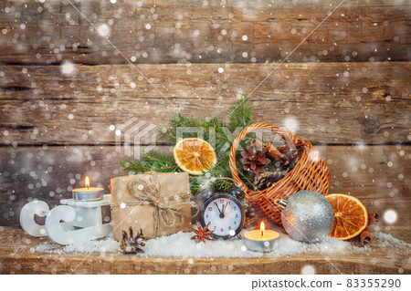 Classic Christmas composition winter objects alarm clock gift box basket fir branch ornaments on wooden background. Christmas New Year Xmas december banner. Time for celebration concept. Classic Christmas composition winter objects alarm clock gift box basket fir branch ornaments on wooden background. Christmas New Year Xmas december banner. Time for celebration concept. 83355290