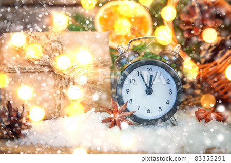 Classic Christmas composition winter objects alarm clock gift box ornaments on wooden background. Christmas New Year Xmas december banner. Time for celebration concept. Classic Christmas composition winter objects alarm clock gift box ornaments on wooden background. Christmas New Year Xmas december banner. Time for celebration concept. 83355291