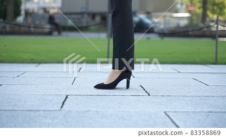 Women's feet wearing high heels 83358869