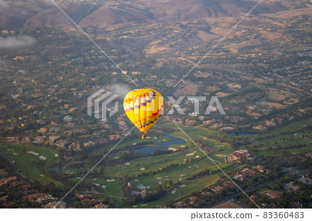 Colorful hot air balloons in the sky with San Diego valley Colorful hot air balloons in the sky with San Diego valley 83360483