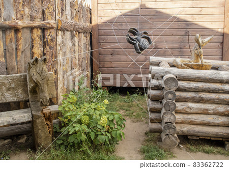 Characters of Russian folk tales carved from wood next to a well and a bench in Sviyazhsk, Russia Characters of Russian folk tales carved from wood next to a well and a bench in Sviyazhsk, Russia 83362722